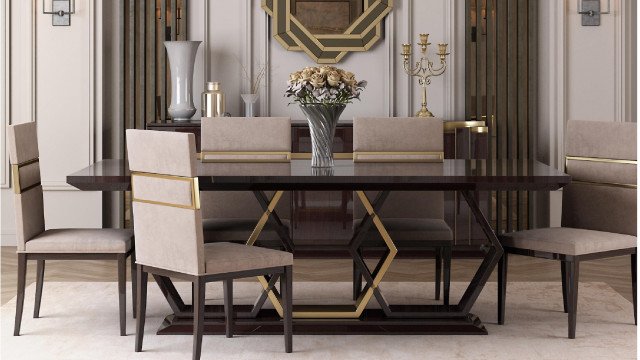 This is an image of a bright and modern interior design. The room features large white and gray walls, a luxurious gray velvet sofa, an ornate mirrored wall, an elegant crystal chandelier, and a stylish light green rug. At the center of the room is a square glass coffee table with a gold frame.