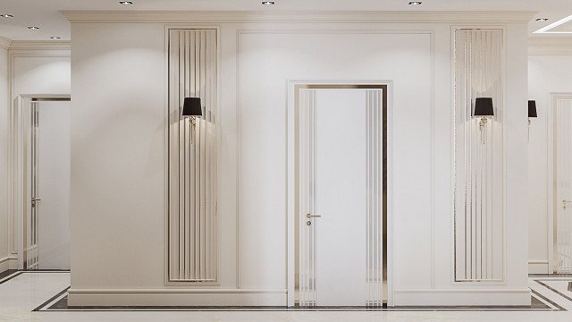 This picture shows the interior of a luxurious modern mansion. It features a grand staircase with ornate metal railings and marble steps, large chandeliers, high ceilings with decorative details, and a combination of light-colored walls, dark lines, and wooden floors. The room also includes comfortable seating with traditional furniture, artwork on the walls, and a staircase that leads to a second floor balcony.