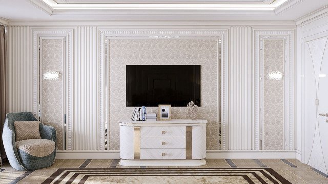 This picture shows an elegant and modern living room. The room features a white sofa set and two matching armchairs, along with a glass coffee table, gray shag rug, and a white wall shelf. The neutral colors of the furniture and accessories create a calming atmosphere in the space, while the large windows provide plenty of natural light. Other decorative touches, such as the delicate curtains, potted plants, and framed wall art complete the look.