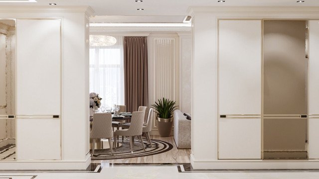 The picture shows a luxurious bedroom with a pristine white, ornate canopy bed. The room is decorated in an elegantly modern style with a sleek white marble floor and walls. There is a crystal chandelier hanging from the ceiling, and two chairs with cream velvet upholstery placed against the wall. A mirrored wardrobe sits on the opposite side of the room, topped by a jewel-toned glass table filled with potted plants, and two silver lamps providing a warm light in the evening.