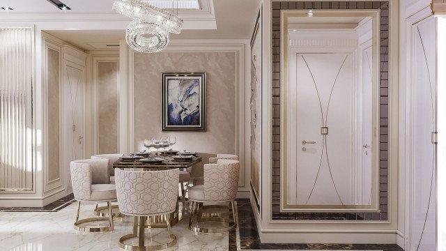 Modern, high-end kitchen with a large center island featuring white and grey marble countertop, black cabinetry, stainless steel oven and appliances, and a silver pendant light fixture.