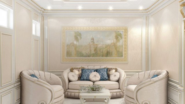 The picture shows a stunningly decorated living room with a contemporary style. The room features a beige colored sofa and armchairs, which have cushions of a light green color. There is also an ornate, gold colored coffee table and a wooden console table against the wall. There are two large paintings on the wall, and the floor has been covered in intricate gray and white tiles. The room has beautiful, vaulted ceilings with lighting fixtures that add to the decorative appeal.