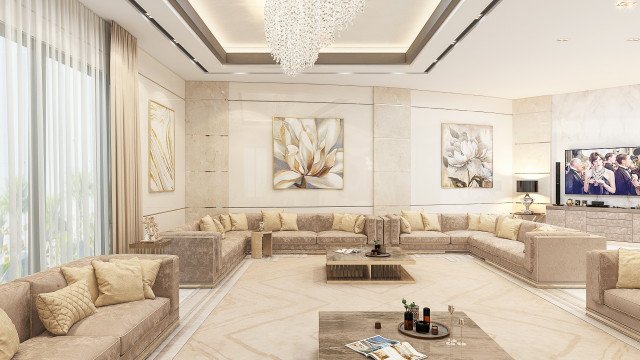 Interior of a living room with a wall featuring ornately-carved wooden panels, two maroon-colored armchairs with white and gold pillows, a wooden table with gold accents, and an ornate ivory-colored ceiling.