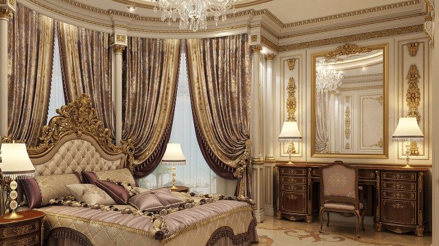 This picture shows a luxurious and modern bedroom. The walls and ceiling are white, with gold and beige accents. There is expensive furniture, including a large bed with a patterned headboard and several decorative pillows. A floor-to-ceiling window offers a view of the city. On either side of the bed are two tall nightstands with ornate lamps, and off to one side is a comfortable armchair and ottoman. On the wall above the bed hangs an elaborate chandelier.