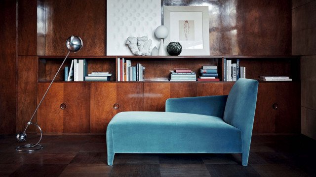 Modern luxury living room design with chandelier, velvet sectional sofa, and stylish wall accents.