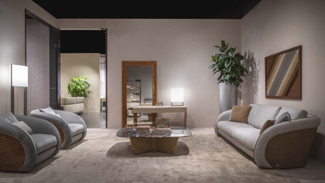 Modern interior design featuring a plush velvet sofa, velvet armchair, crystal chandelier, and marble flooring.