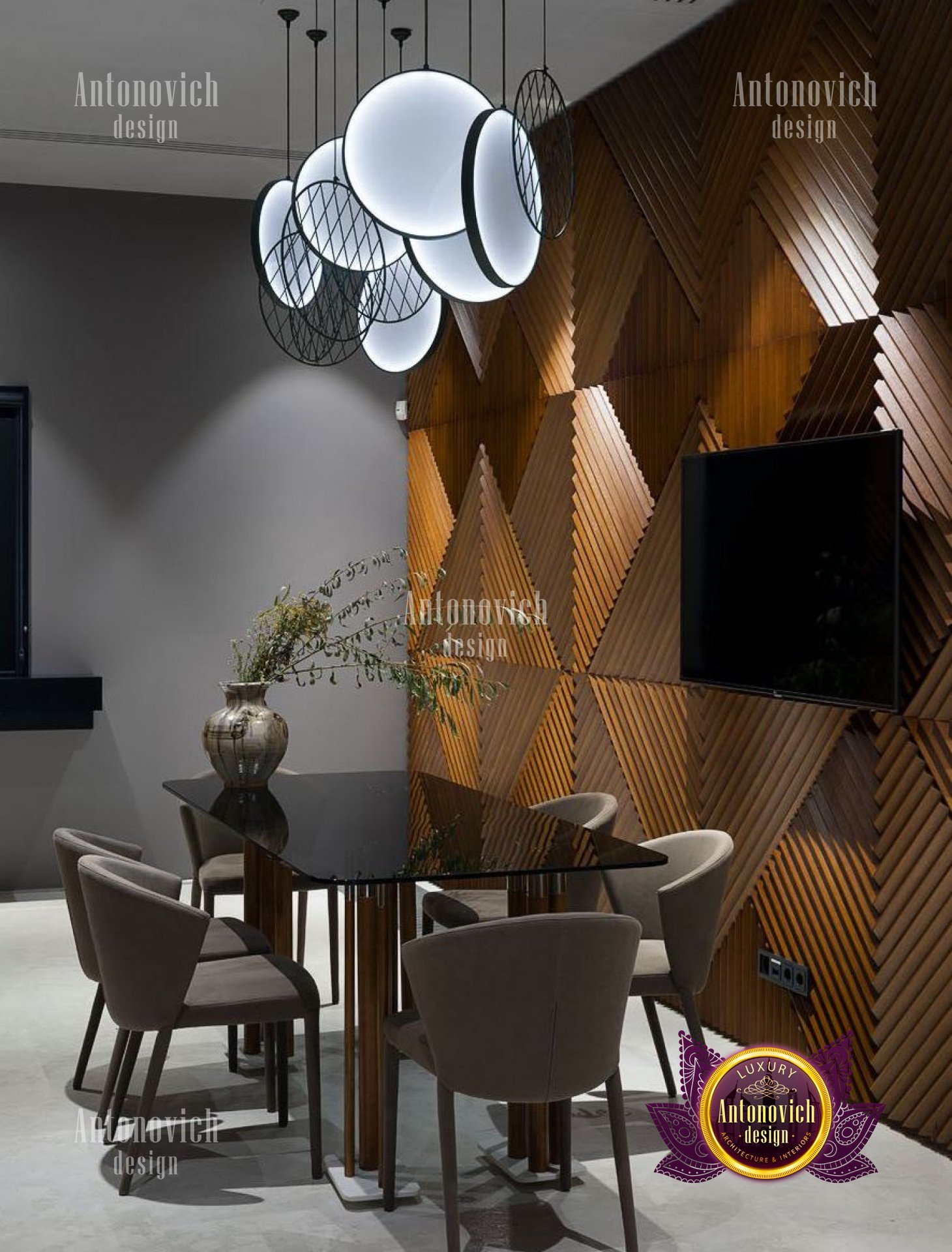 A modern luxury interior featuring a white, curved marble staircase leading up to a second story floor with walls decorated with art and framed photographs.