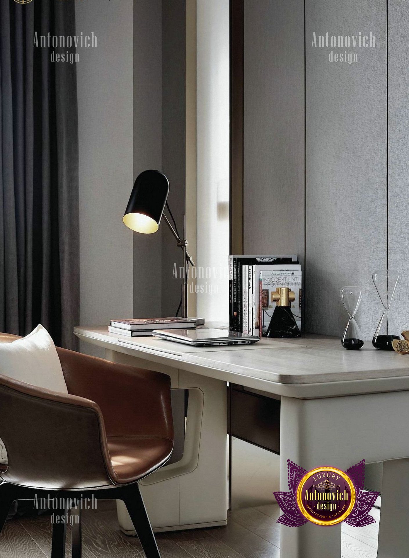 This picture shows a luxurious, modern living room with a beautifully appointed seating area. The main focus is on two deep armchairs sitting in front of a large stone fireplace, flanked by tall windows with long, white curtains. A large, plush burgundy area rug covers the coffee table and white porcelain vases adorn the shelves. The walls are painted in a soft beige color, while the ceiling is adorned with an intricate chandelier and recessed lighting.