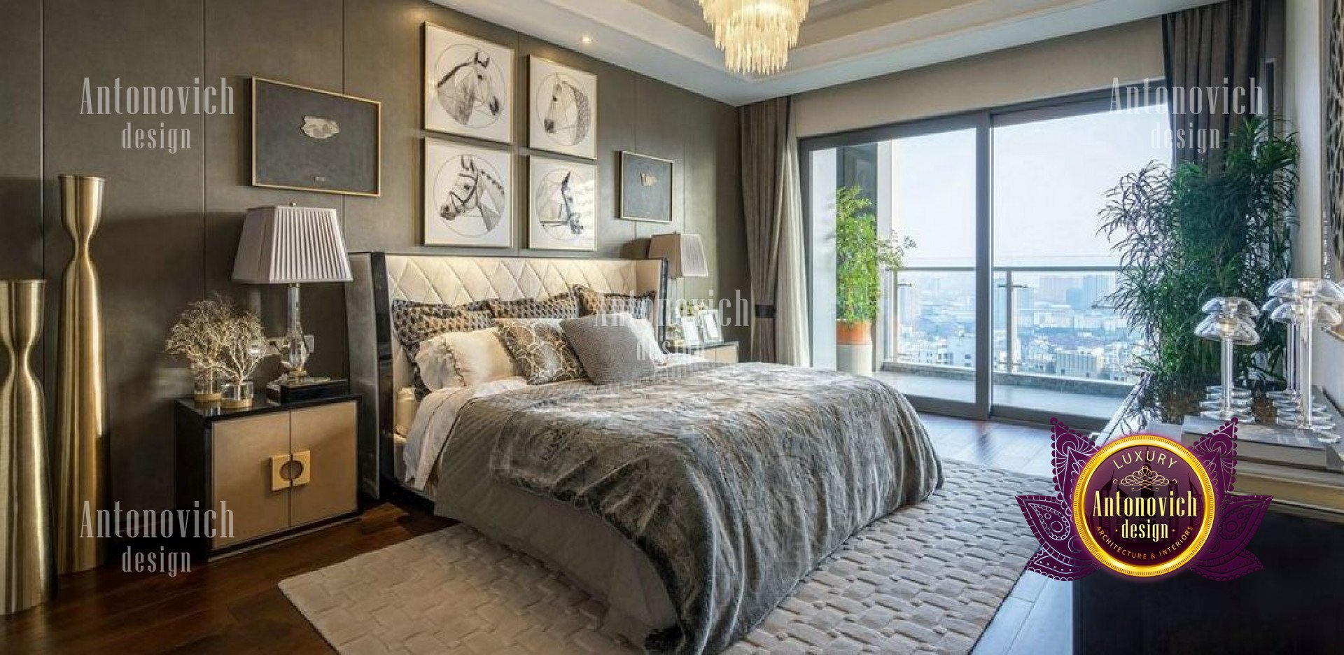 This is a picture of an elegant luxury bedroom in a modern home. The walls are painted a light beige color, with wide white trim framing the perimeter of the room. A large floor-to-ceiling window is off to one side, letting in a lot of natural light, while the center of the room features a large bed with a dark gray tufted headboard flanked by two mirrored nightstands. On the left side of the bed is a chaise lounge with a decorative pillow, while on the right is a plush white armchair and ottoman. The