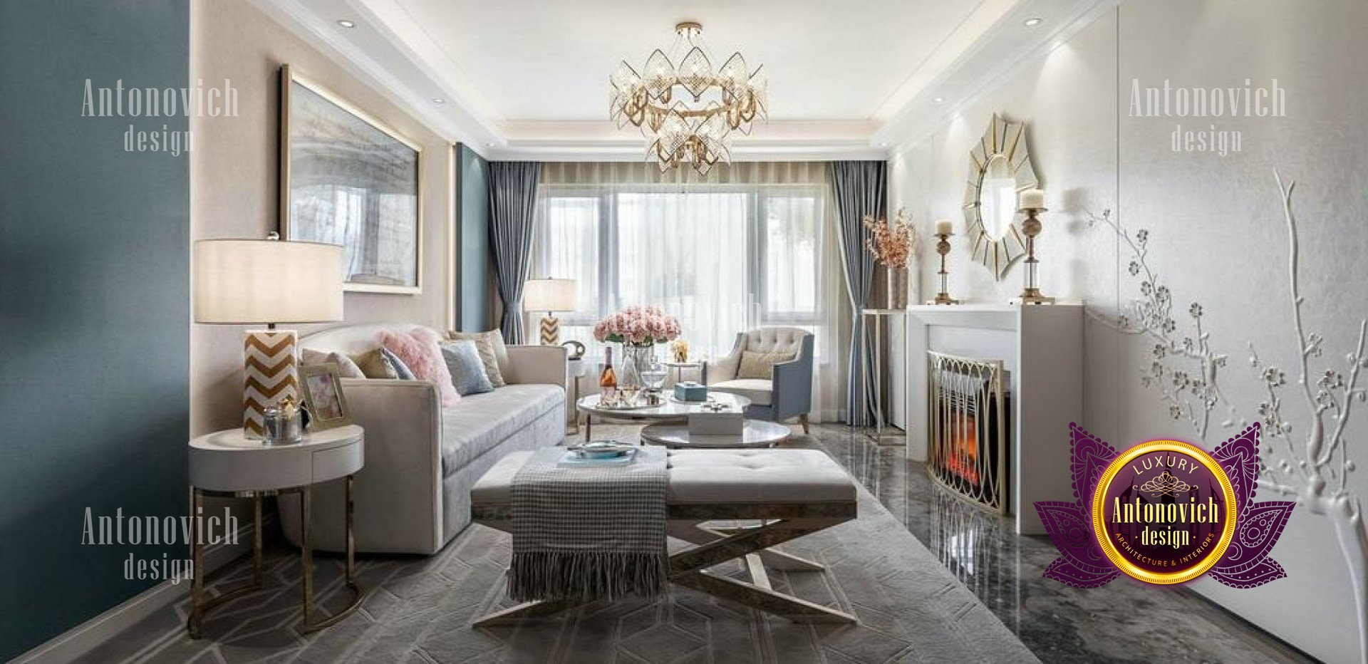 This picture shows an elegant furnishings of a modern living room. The focal point of the room is the white leather sofa, which is complemented by two matching armchairs. There is also a brown coffee table with glass top in the center of the room, and a thick rug with beige, black, and red details. Along one wall, a modern fireplace is surrounded by wood panels and decorated with a large wall-mounted painting. Finally, several plants bring a touch of greenery to the room.