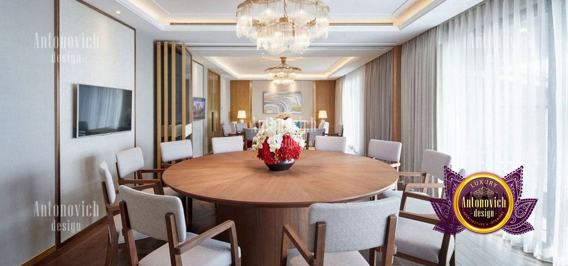 This picture shows an ornate modern living room designed by Antonovich Design. The room is decorated in luxurious materials such as marble, gold, and velvet. There is a central seating area with two large furniture pieces, an armchair and sofa, facing each other. The walls are covered with golden wallpaper with intricate patterns and tiles. The ceiling is also decorated with gold accents and features a large, ornate chandelier. A variety of decorative accents, such as vases and sculptures, can be seen throughout the space.