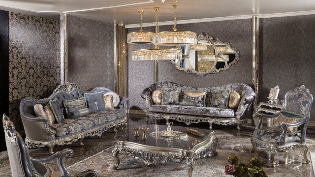 Modern luxury living room featuring a decorative fireplace, seating area with velvet upholstery, and an ornate chandelier.