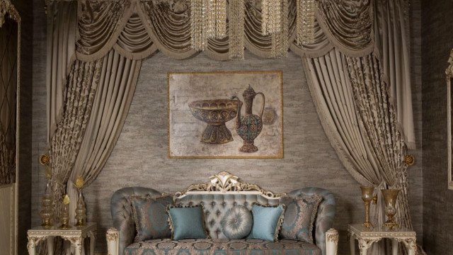 A modern, contemporary living room with white marble flooring, a velvet sofa, and a large crystal chandelier.