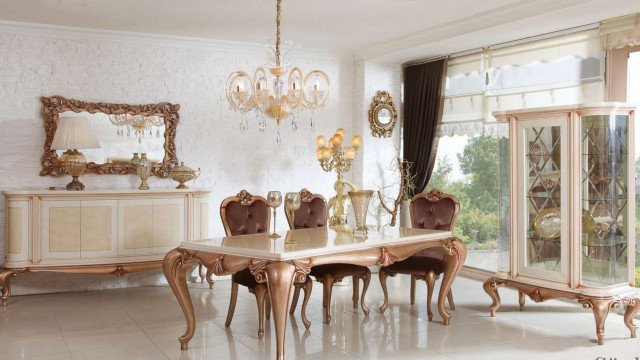 Red and gold decorated interior with luxurious furniture and artwork.