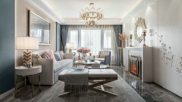 This picture shows an elegant furnishings of a modern living room. The focal point of the room is the white leather sofa, which is complemented by two matching armchairs. There is also a brown coffee table with glass top in the center of the room, and a thick rug with beige, black, and red details. Along one wall, a modern fireplace is surrounded by wood panels and decorated with a large wall-mounted painting. Finally, several plants bring a touch of greenery to the room.