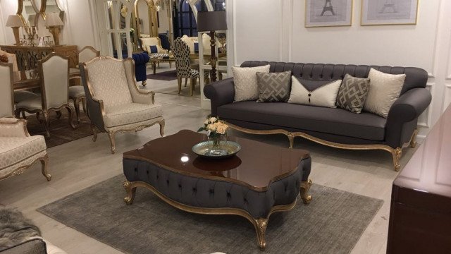 Modern, spacious and luxurious living room design showing the beauty of art deco style with gold accent furniture.