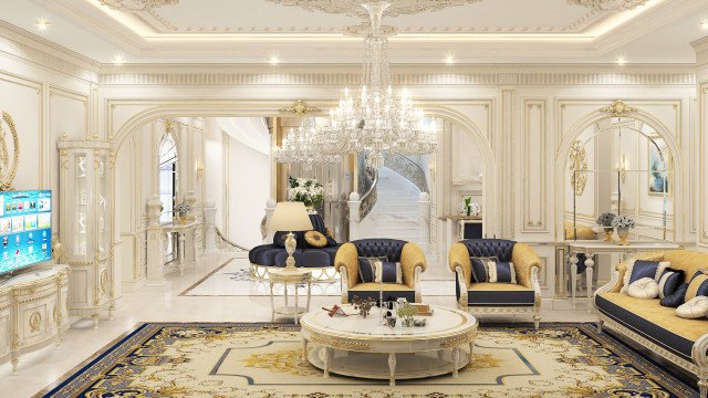 This picture shows a luxurious and spacious entryway with marble walls, columns, and a large crystal chandelier. The floor is a mosaic pattern of marble tiles, and the ceiling is ornately decorated with gold accents and other intricate details. A grand staircase curves from the entryway to the upper floors and a glass entry door allows natural light to fill the space.