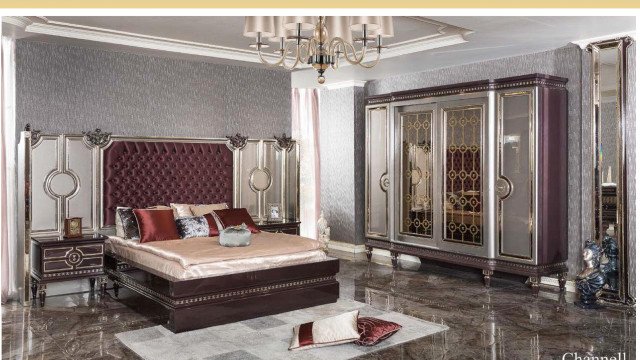 Modern interior consisting of geometric furniture, artworks, and accessories in neutral colors with gold trim accents.