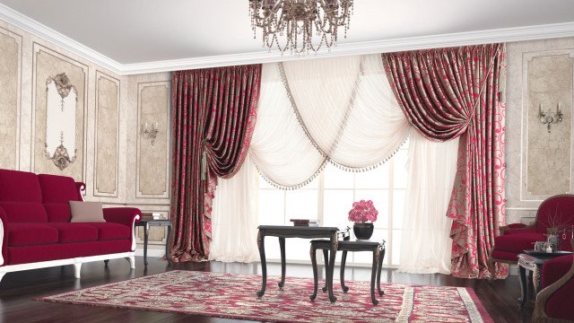 This is a picture of a modern luxury living room designed by Antonovich Design. It features an elegant white and gold palette, with white walls and light hardwood floors creating a bright and inviting atmosphere. The furniture consists of two beige sofas, a white armchair, two side chairs with gold legs, a white coffee table, and a fireplace with a white mantel. The room also includes several pieces of wall art, a rug, and multiple side tables.