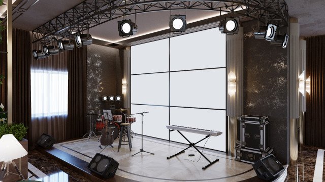 This picture shows a contemporary style living room with a large window and white walls. There is a large white sectional couch, a white coffee table, a grey shag rug, and a black side table with a decorative lamp. The windowsill has a few plants and a white drape which adds texture to the room. A wall-mounted television is above the couch and there are several pieces of art decorating the walls.