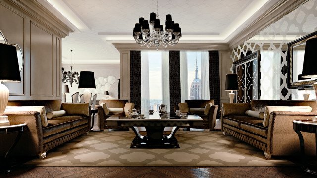 This picture shows a luxurious living room designed with elegant furniture and decor. It features two beige couches with floral-patterned cushions, a glass coffee table, a taupe armchair, a white round marble-top side table, and a black and white rug. The walls are painted a light shade of gray and the room is illuminated by various light fixtures, including a stylish chandelier that hangs from the ceiling.