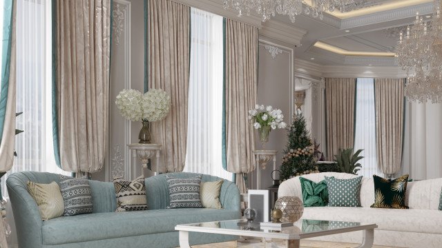 This picture shows an elegant, modern living room. The walls are covered in a light blue wallpaper with a subtle pattern, while the furniture is finished in a pale wood. The main seating area features a luxurious velvet sofa and armchair in a deep teal, which is accented by a round, glass coffee table and two side tables with white marble tops. The floor is covered in a light grey rug that has a botanical pattern. A mirror hangs on the wall above the sofa, and various pieces of artwork are scattered around the room.