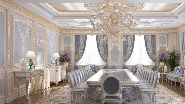 This picture displays a luxurious entryway with a unique and elegant style. The walls are made of dark wooden panels, which are illuminated by recessed lighting along the perimeter. A statement-making staircase with a sleek metal balustrade curves gracefully around to the second floor, with a stunning chandelier suspended from above. Two accent chairs are positioned on either side of the stairs, with matching side tables and decorative flower arrangements. The grand marble floor is accented with a large ornamental rug, and a beautiful mirror is hung on the wall at the top of the stairs.