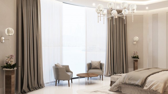 A modern white sofa with two dark grey chairs and a glass coffee table in a minimalist, contemporary living room.