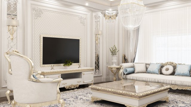 This picture shows a modern-style living room with light wood flooring, off-white walls, and contemporary furniture. The focal point of the space is a statement mirror suspended from the ceiling above a low white sofa. Additional seating is provided by two cream chairs and a white coffee table. A patterned area rug adds a touch of color, while sheer drapes provide subtle privacy. Green plants bring natural elements to the otherwise minimalist design.
