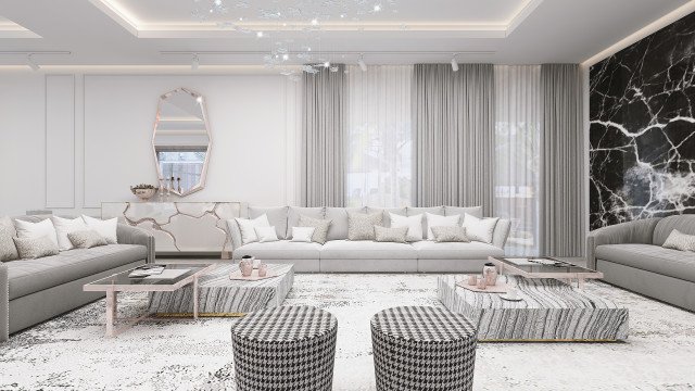 Modern living room featuring white walls, exposed ceiling beams and a grey sectional sofa. White marble flooring and beige area rug.