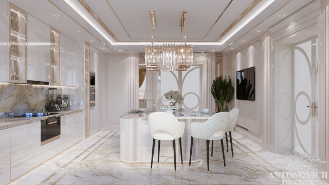 This picture shows a luxurious modern interior with glossy cream-colored cabinets, walls and accent furniture. The cabinets are adorned with brass hardware and gold trim, while the walls are covered in textured wallpaper that adds depth and character to the room. The accents of black and white contrast against the cream, creating a striking visual effect. There is also an elegant mirror and an ornate chandelier for added glamour.
