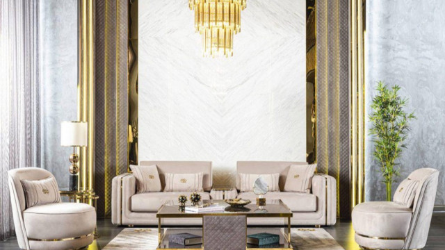 A modern luxury living room featuring a white sofa, a beige armchair, a brown coffee table, and a statement rug.