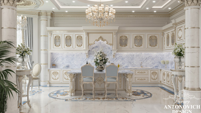 This picture shows a luxurious interior design. The focal point of the image is an elegant grand white staircase that curves to the second floor. The walls are painted in a cream colour, and the marble floors have intricate patterns. There is a gold chandelier suspended from the ceiling, and a large grand mirror hangs above the stairs. Along the bottom of the stairs are plush velvet chairs in a rich deep blue colour. The doorways and walls have detailed carvings lined with gold accents.