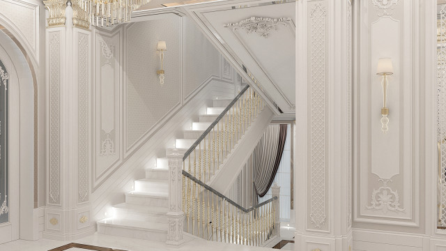 An elegant luxury wooden staircase with twin flights of steps, side-by-side wooden railings, and a polished marble floor.