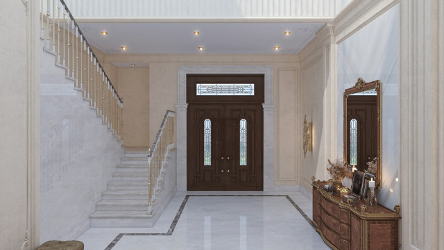 A modern living room featuring neutral tones, leather furniture, and an ornate light fixture.