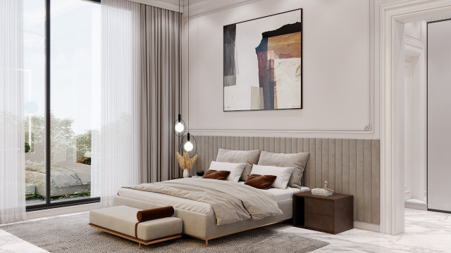 This picture shows a grand, modern bedroom with several luxurious amenities. The walls are painted a light grey and the flooring is white marble. There are two floor-to-ceiling windows on either side of the room that are lined with white drapery. In the center of the room there is a large bed with pale pink bedding and silver accents. On either side of the bed there are night stands topped with silver lamps. In the corner there is a gold and white armchair with an ottoman. To the right of the bed there is a built-in wardrobe
