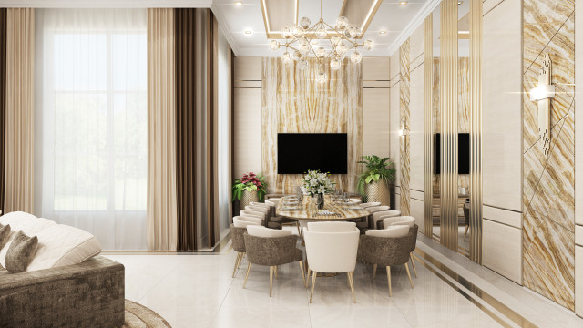 This picture shows an elegant and luxurious living room. The walls are covered in a warm, creamy off-white, with a darker granite floor. Large windows reveal a stunning view of the city skyline. The room is furnished with a white sectional sofa, two armchairs, and a black and gold coffee table. On the walls hang large gold-framed abstract art pieces. An ornate crystal chandelier hangs overhead creating ambient lighting.