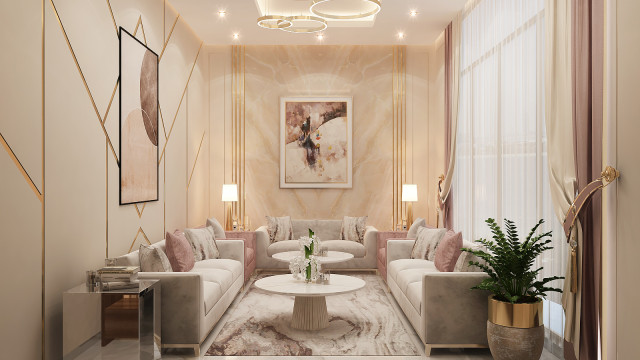 This picture shows a luxurious and modern home interior designed by Antonovich Design. The space is dominated by a giant cream-colored sofa that stands out from the dark grey walls and flooring. There is a large, round coffee table in the center of the room, with an abstract painting and a small potted plant for decoration. On either side of the sofa are two armchairs with matching cream leather upholstery that tie together the look. The large windows provide plenty of natural light, while the glass ceiling fixtures add extra illumination.