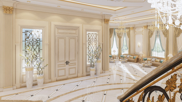 This picture depicts an interior design from Antonovich Design, showcasing a luxurious living room with dark blue velour sofas and armchairs, an ornate white coffee table, and an elegant chandelier hanging from the ceiling. The walls have a white textured pattern and are decorated with framed artwork. The overall look is opulent and sophisticated.