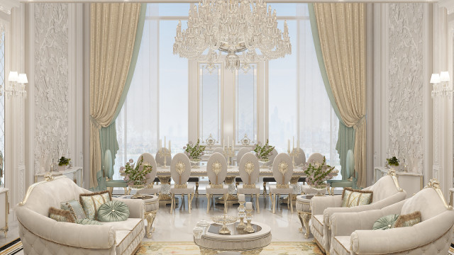 This picture shows a luxurious living room with a modern contemporary design. The room features a luxurious cream sofa, two gold armchairs with white cushions, and a stunning center table with a glass top surrounded by polished marble flooring. The walls are painted in light grey with a beautiful patterned wallpaper that adds texture to the room. On the wall is an ornate mirror with a gold frame and a matching sconce. The furniture is accented with various pieces of art and some decorative plants for added beauty and ambience.