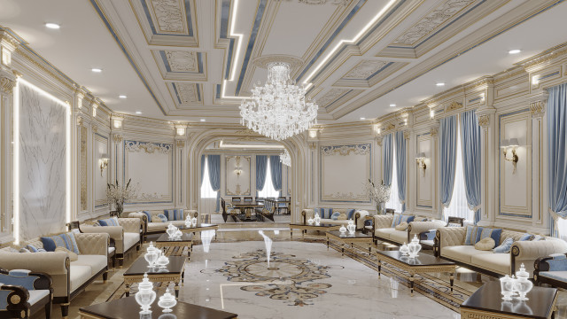 This picture is of a modern interior design by Antonovich Design. The room features white and light grey walls, a built-in grey sofa, a black marble coffee table, a round white ottoman, and two black and white armchairs. There is also a stylish white and grey patterned rug on the floor, and a modern chandelier hanging from the ceiling.