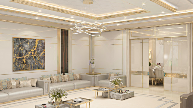 This picture is an image of a modern and luxurious living room. It features a glossy white marble floor, a white sofa with gold accent pillows, navy velvet armchairs, several glass coffee tables and a large, round chandelier hanging above. The walls are covered in an ivory wallpaper with white trim, and there are several plants scattered around the room. The overall look is inviting and sophisticated.