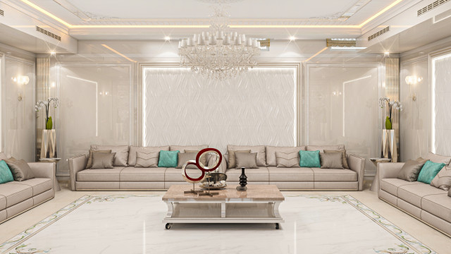 This picture shows an elegant, modern living room designed in white and grey tones. The walls are painted in a light grey color, and the ceiling and parts of the walls are decorated with white moldings. The room features a comfortable couch with several pillows, a large round rug, a glass coffee table, and two white armchairs. In addition, there is a modern white fireplace with a surrounding wall and an abstract painting above it. On the other side of the room is an open plan dining area with a unique black dining table, four chairs, a stylish chandelier, and