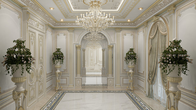 This picture shows a luxurious grand entrance hall with marble floors, white walls, and a ceiling with gold chandeliers. The walls are decorated with a stylish patterned wallpaper, and the center of the room features a large crystal staircase leading up to the second floor. On either side of the staircase are two large paintings, and the room is finished with several comfortable couches and ornate lamps for lighting.
