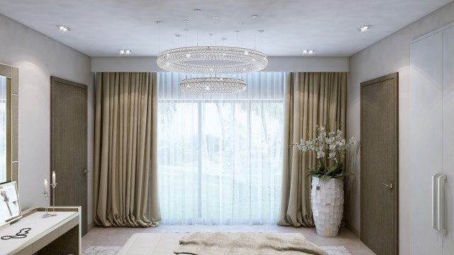 This image shows a modern living room that has been designed with contemporary flair. The room features a white and gray color palette, with dark wood accents throughout the space. The room includes a large sectional sofa in light gray upholstery, paired with a matching ottoman in a sleek patterned upholstery. A large white coffee table sits in front of the sofa, with a black decorative bowl and a basket resting atop it. On the walls, two abstract paintings in shades of blue and orange provide an interesting accent to the space. The room also features a large rug in shades