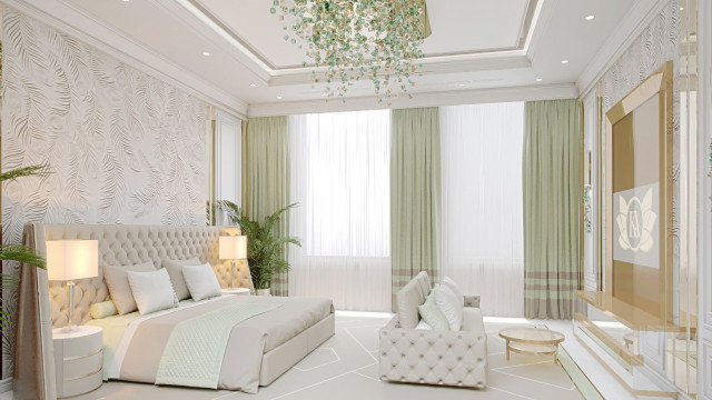 jpgThis picture is of a spacious modern living space with comfortable furnishings and decorations. The space features a large light gray L-shaped sofa with decorative pillows, a round white coffee table with a patterned rug, several wall art pieces, and two tall decorative plants. The walls are covered in a soft beige wallpaper, and there is also a grand ceiling lamp illuminating the whole room.