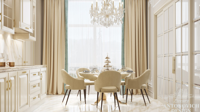 An ornate, modern living room featuring light-colored furniture, artwork on the walls, and a large chandelier.