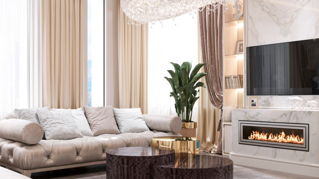 This picture shows an interior design from Antonovich Design. It features a large modern living room with light hardwood flooring, beige walls, a ceiling and window treatments. A contemporary white soffa and armchairs are set up in the center of the room, and a grey carpet is placed in the middle of the seating area. A brown wooden sideboard is placed against one wall, and an abstract painting hangs on the wall next to it. An ornate chandelier hangs from the ceiling above the seating area, and two lamps provide additional light.