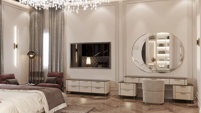 A modern interior room with a beige sofa set and armchair, featuring geometric patterned throw cushions, coffee table, and hanging pendant lights.