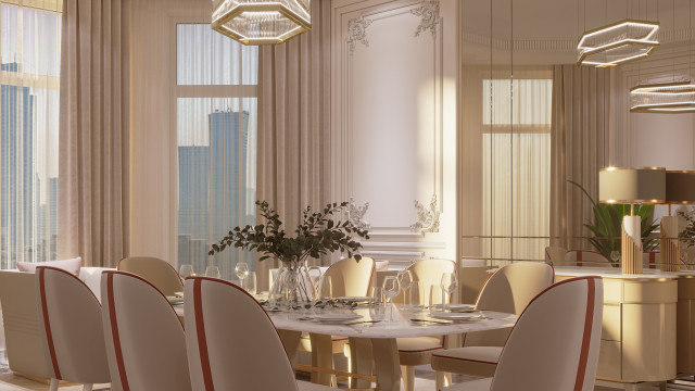 This picture shows an elegant dining room with a luxurious marble table and two velvet chairs. There is a stunning crystal chandelier hanging above the table, which provides a calming light to the space. The walls are covered in a cream wallpaper with gold accents, and there are white shutters on the windows. A floral rug with shades of blues and creams adds texture and warmth to the room.